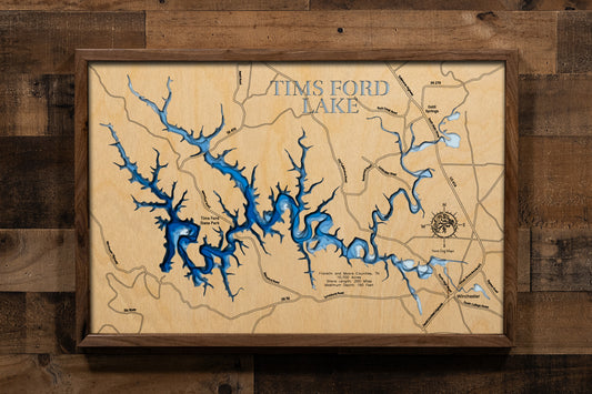 A meticulously crafted, multi-layered laser-cut wooden topographic map of Tims Ford Lake in Franklin and Moore Counties, Tennessee. The detailed design illustrates the reservoir's 34-mile length along the winding Elk River channel, 250 miles of intricate shoreline with numerous coves and embayments, depth contours revealing the 150-foot maximum depth near the dam, and the six distinctive islands scattered throughout the lake.