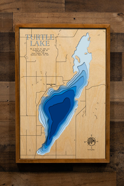 A high-quality 3D laser-cut wooden map of Turtle Lake in 
Saskatchewan, Canada. The map features a natural wood top layer 
contrasted with recessed water layers stained in a light-to-dark 
blue gradient, showcasing the 36-mile shoreline and 63-foot maximum 
depth. This elegant topographic art piece highlights the unique 
contours of the reservoir and its many resort hamlets, making it a 
perfect commemorative gift or sophisticated decor item for a 
lakeside home or office.