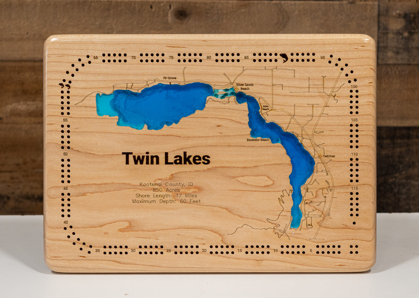 A precision laser-cut, multi-layered wooden map of Twin Lakes in 
Kootenai County, Idaho. The natural wood top layer meticulously 
captures the 17-mile shoreline, while the recessed water layers 
feature a vibrant light-to-dark blue gradient representing the 
60-foot depth. This elegant 3D topographic art piece is a 
sophisticated home decor item, perfect for cabin walls or modern 
interiors looking for a rustic, handcrafted touch.