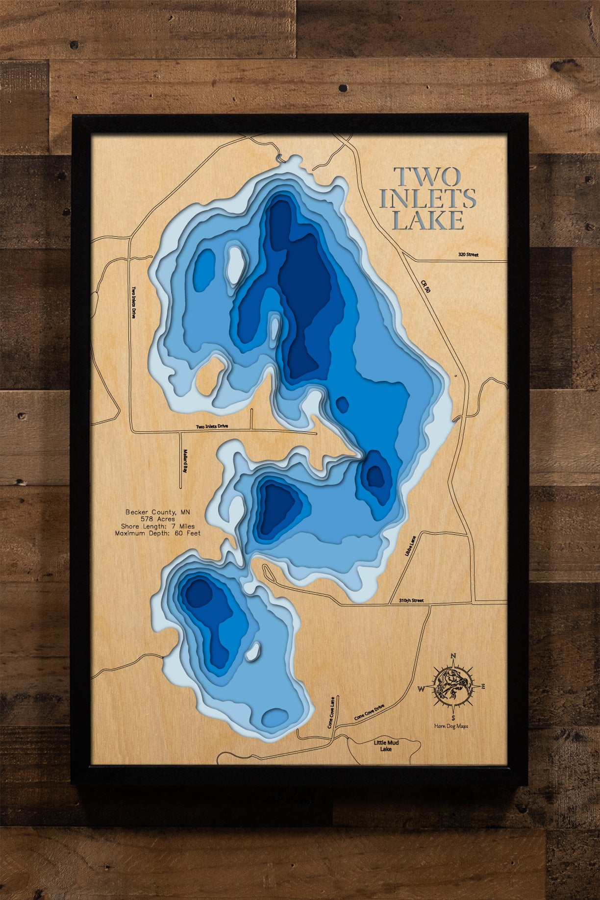 A beautifully crafted, laser-cut wooden topographic map of Two Inlets Lake in Becker County, Minnesota, featuring layered depth contours revealing the 60-foot maximum depth, the 578-acre irregularly shaped basin with seven miles of winding shoreline through woodlands, the distinctive two inlet streams meeting at nearly the same point, the northwest public boat launch, and the surrounding Two Inlets State Forest terrain characteristic of Minnesota's pristine lake country.