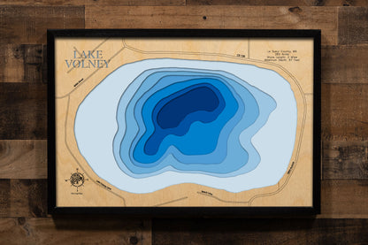 A precision laser-cut, multi-layered wooden map of Lake Volney in Le Sueur County, Minnesota, a 283-acre lake near Le Center and Kilkenny that ranks among the deepest in the Waterville area at 67 feet. The natural wood top layer captures 2 miles of shoreline in fine detail, while a light-to-dark blue gradient conveys the lake's impressive depth. A handcrafted statement piece for any Minnesota lake home, cabin, or outdoor enthusiast's wall.