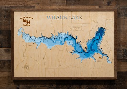 A laser-cut, layered wooden map of Wilson Lake, located in Russell and Lincoln Counties, Kansas. The shape of the reservoir, nestled within the Smoky Hills, is clearly visible within the central Kansas landscape. The varying depths of the lake, reaching a maximum of 65 feet, are represented by different layers of wood.