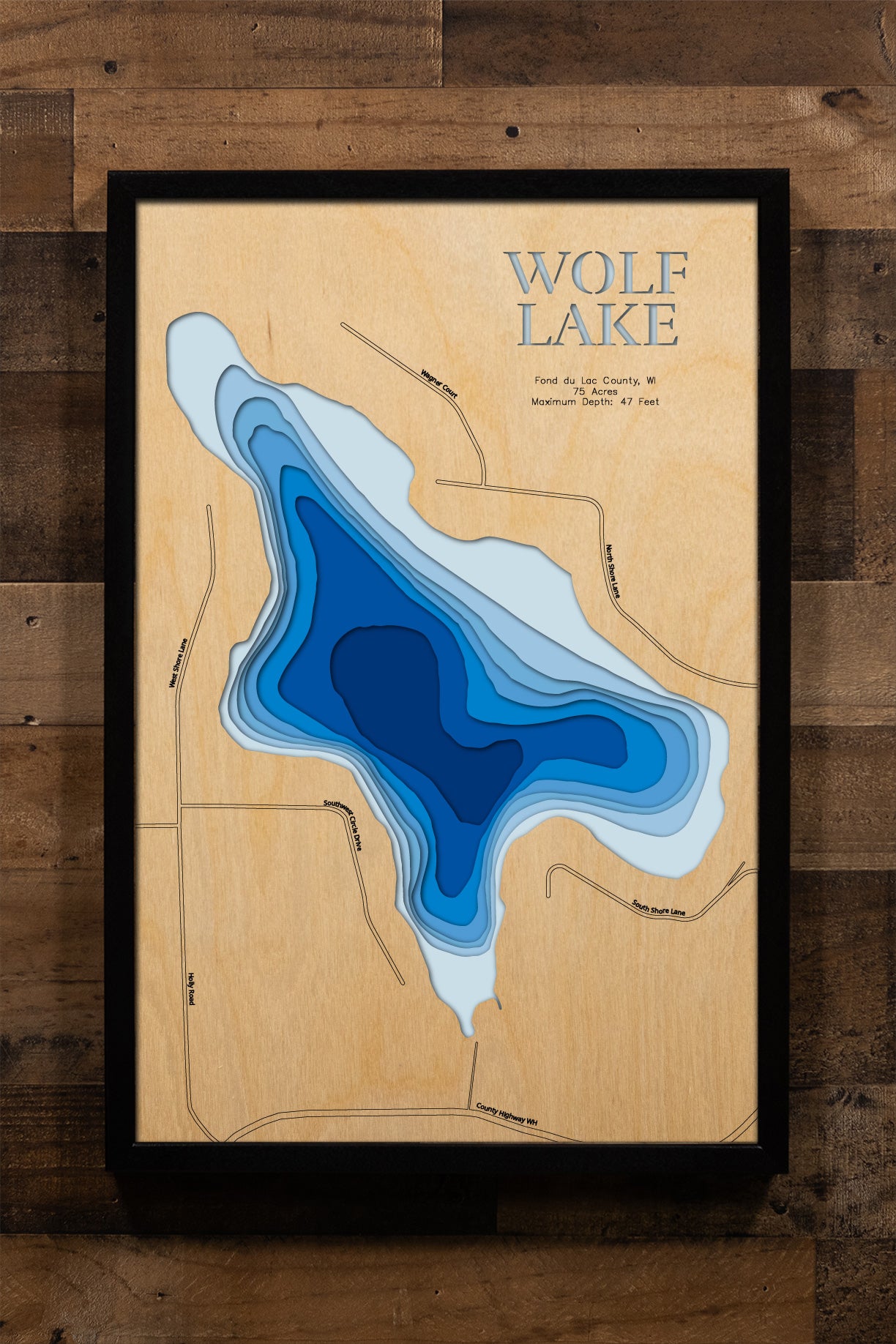A precision laser-cut, multi-layered wooden map of Wolf Lake in Fond du Lac County, Wisconsin. The natural wood top layer captures the shoreline of this peaceful Kettle Moraine-area lake in fine detail, while a light-to-dark blue gradient highlights its 47-foot depth. A handcrafted statement piece for any Wisconsin lake home, cabin, or outdoor enthusiast's wall.
