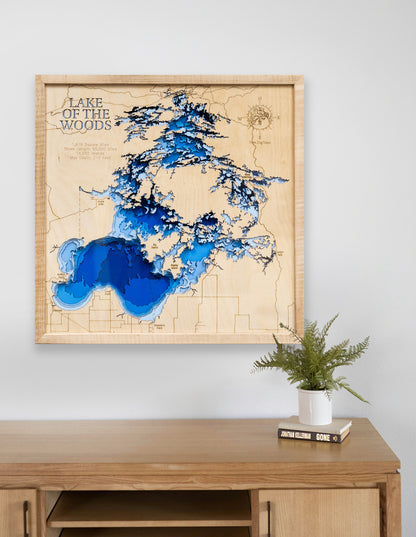 3D Lake of the Woods map in a maple frame displayed above a modern desk, highlighting detailed depths and shorelines.