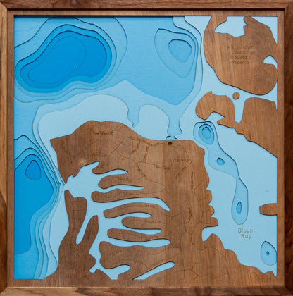 Laser-engraved relief map of Kitty Hawk Bay in North Carolina, crafted from wood with high precision.